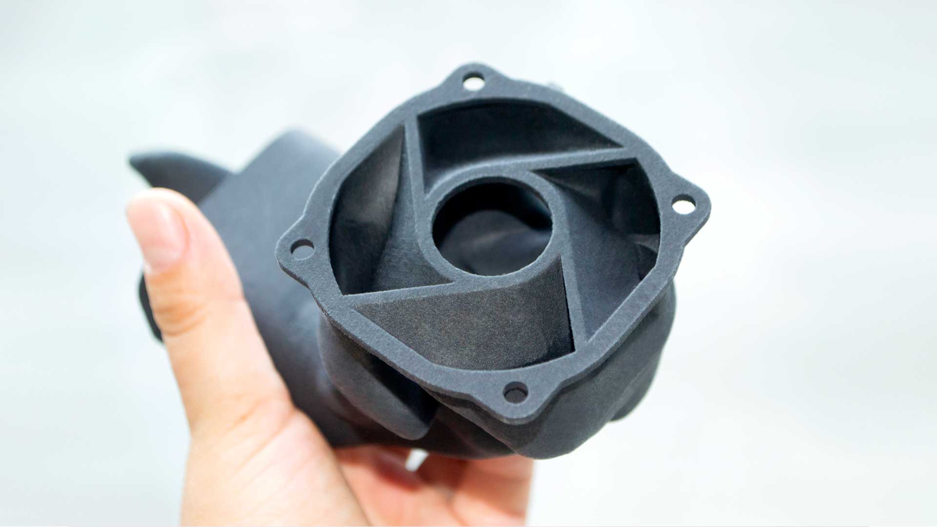 Man holding plastic model printed on powder 3d printer