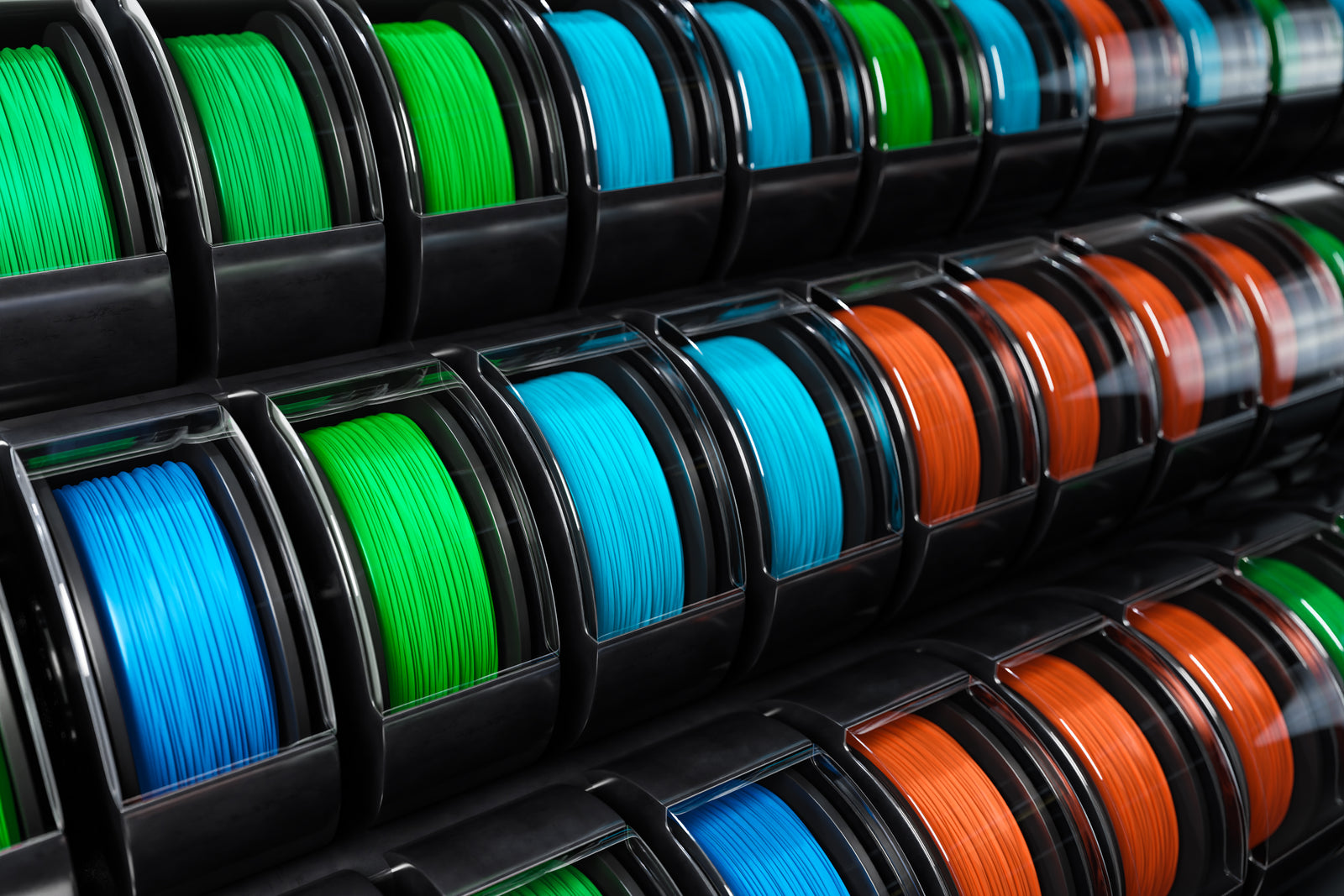 Spools of 3D printer filament in various colors on a black background
