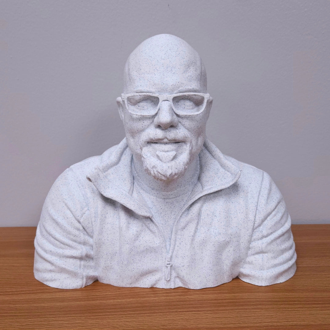 White Marble PLA bust of a man with glasses on a wooden surface