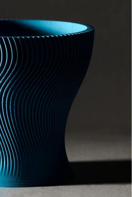 Matte PLA Light Blue textured vase on a dark background